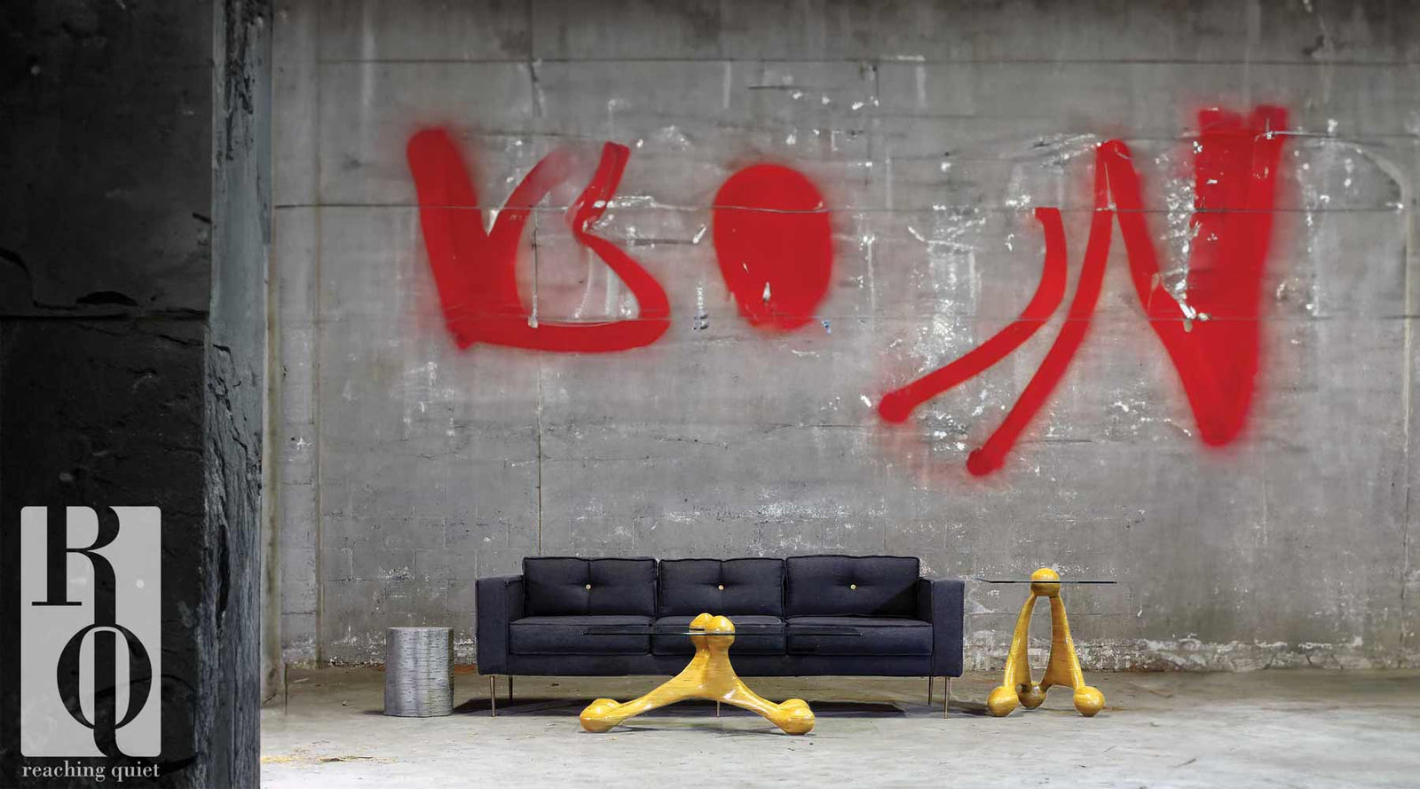 handcrafted modern coffee and end tables with a black sofa that has shotgun shell buttons